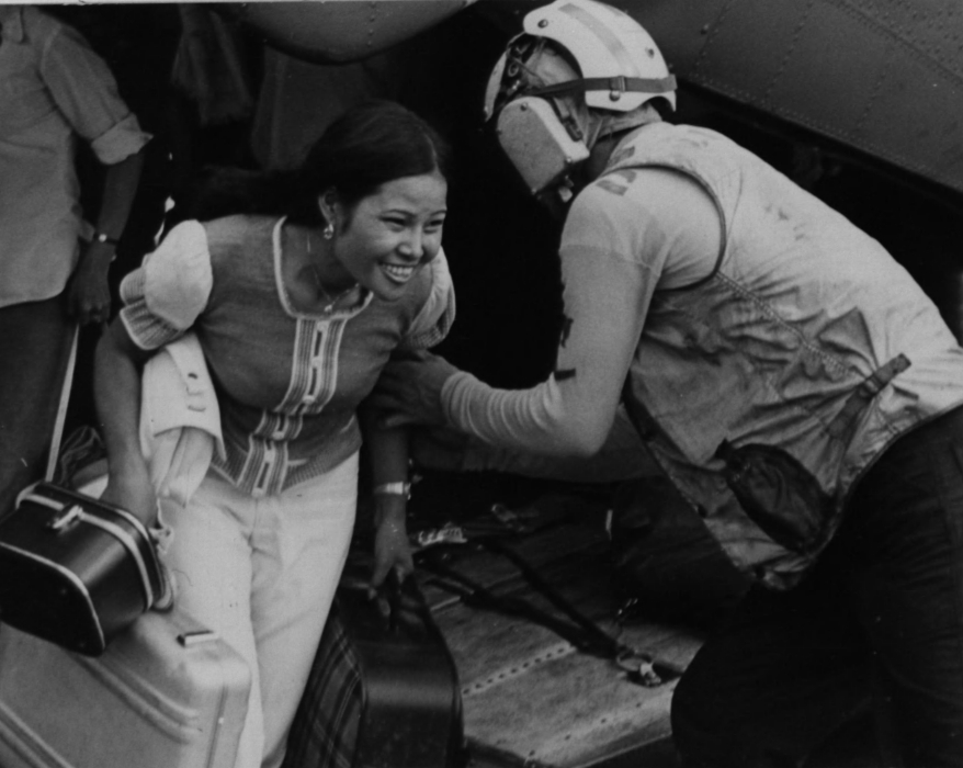 A marine pilot assists a refugee – National Archives Identifier: 26398111