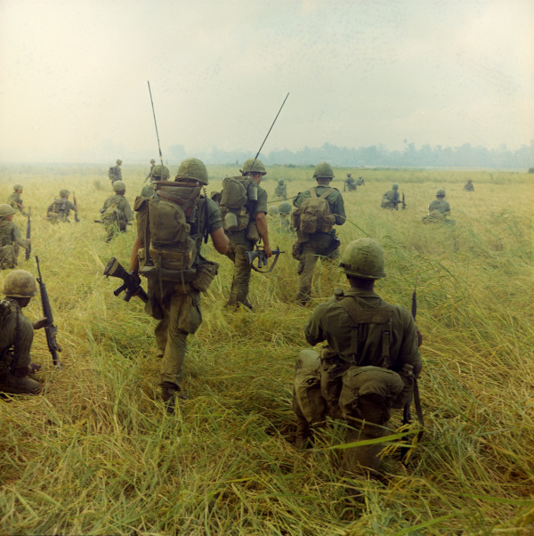 Soldiers of the 327th Infantry, 101st Airborne Brigade, prepare to move across a rice field in search of Viet Cong (VC), January 23, 1966 – National Archives Identifier: 100310304