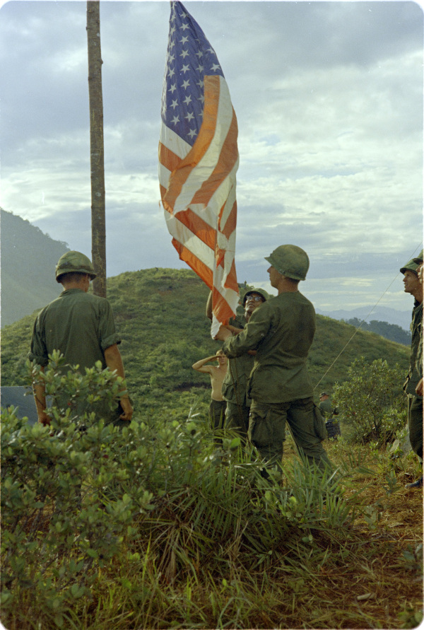Photograph of Members of Headquarters Command Raising the US Flag on Top of Ranger Hill, September 8, 1967 – National Archives Identifier: 66953700